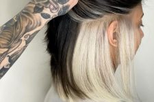medium length hair in black and with platinum blonde underneath as a bold and catchy accent is amazing