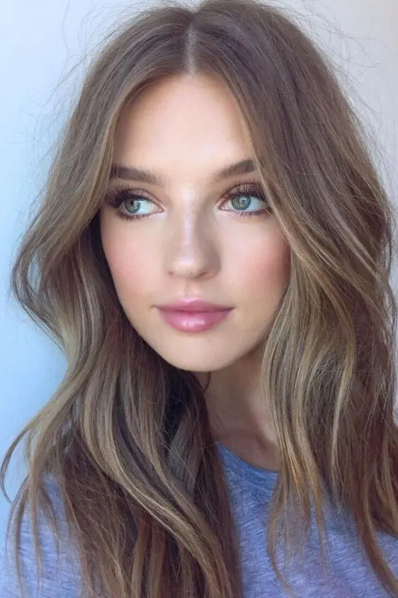 mousy brown hair with gold and blonde babylights and subtle waves for a delicate and beautiful look