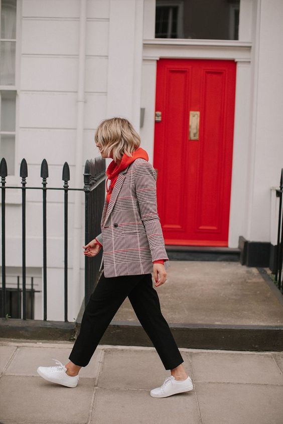 a comfy and casual work outfit with a red hoode, a grey plaid blazer, black cropped pants, white sneakers