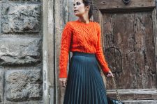 03 a bold fall outfit with an orange patterned sweater, a navy pleated midi, two-tone shoes and a black bag