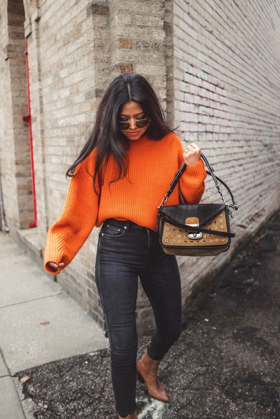 a bold orange jumper, black skinnies, brown cowboy boots, a two tone bag for the fall