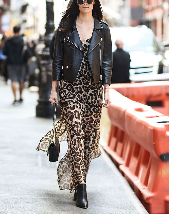 a leopard print maxi skirt, a black leather jacket, black boots and a black bag with chain are a lovely fall combo