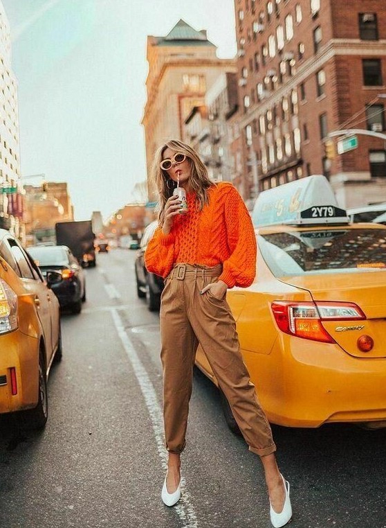 a bold orange patterned sweater, beige pants, white slingbacks are a lovely combo for a fall work look