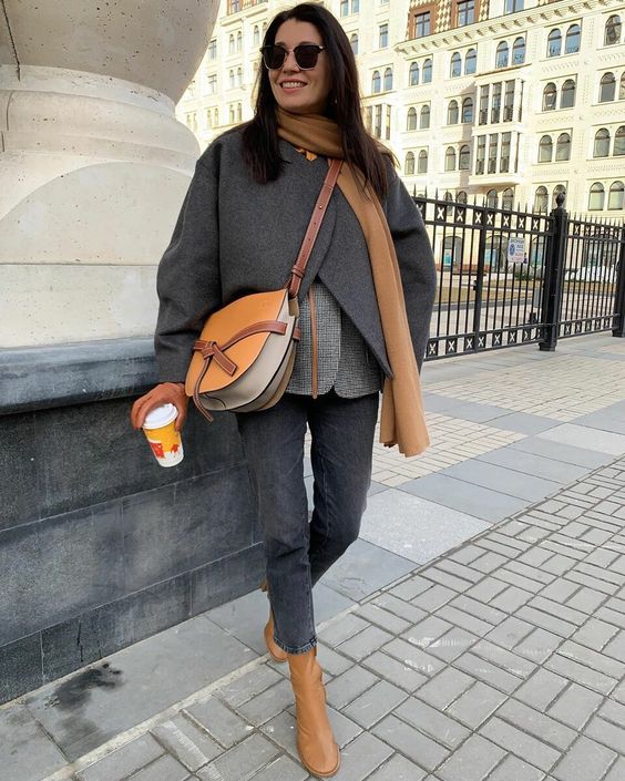 a chic fall outfit in grey and amber, with a plaid blazer, cropped jeans, an overcoat, an amber scarf, bag and boots