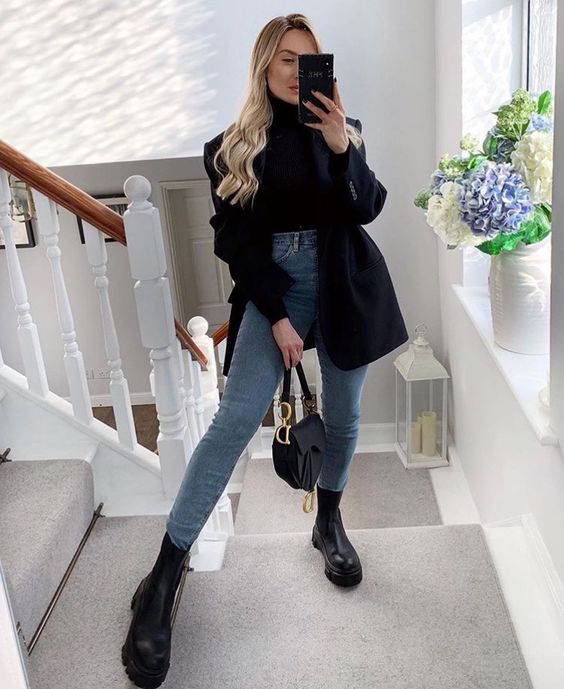 a black turtleneck, blue skinnies, an oversized black blazer, black chunky boots and a small saddle bag