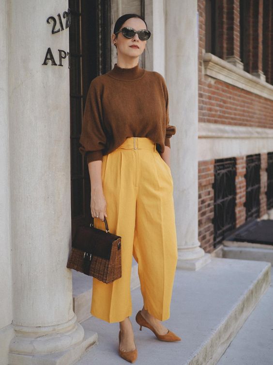 a refined work outfit in fall hues - a brown turtleneck, yellow wideleg cropped pants, bunrt orange shoes and a chic bag