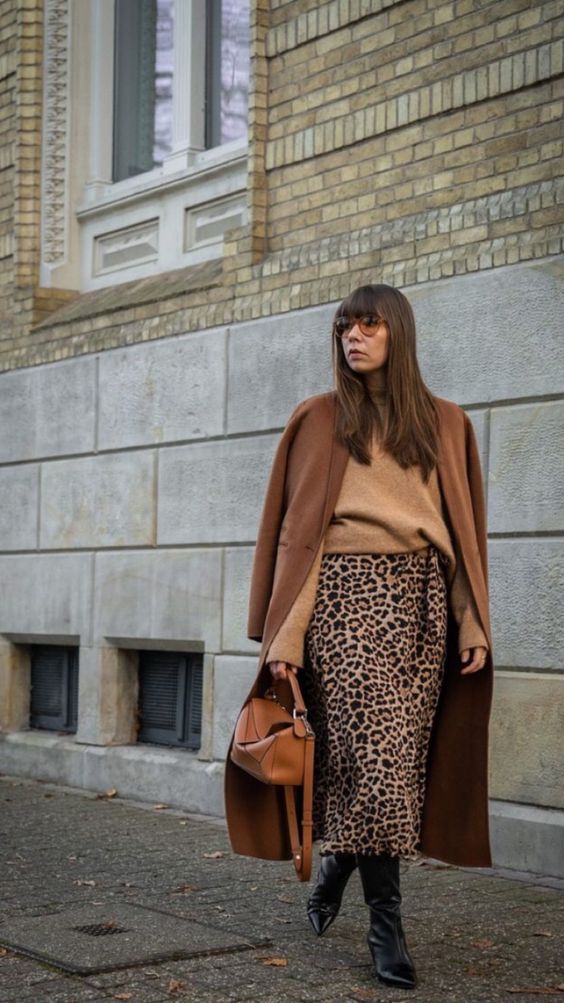 a beige turtleneck, a leopard printed midi, a brown coat, black boots and an amber bag for the fall and winter