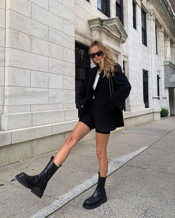 a catchy fall work outfit with a white t-shirt, a black blazer, black shoes, a black bag and black chunky boots