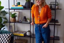 a stylish office look with a bright orange sweater