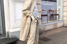 12 a neutral fall work look with a grey hoodie, tan pants, a tan trench and white trainers is super comfortable