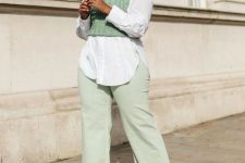 13 a dreamy pastel work outfit with light green jeans, a white shirt, a light green knit vest, snakeskin shoes