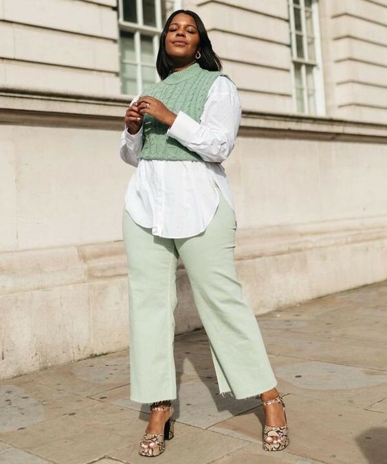 a dreamy pastel work outfit with light green jeans, a white shirt, a light green knit vest, snakeskin shoes