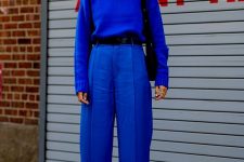 14 a simple bold blue outfit with wideleg high waisted pants, a sweater, white boots and a black bag