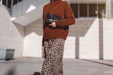 15 a rust-colored turtleneck sweater, a leopard printed midi skirt, black boots and a large black clutch for the fall to winter look