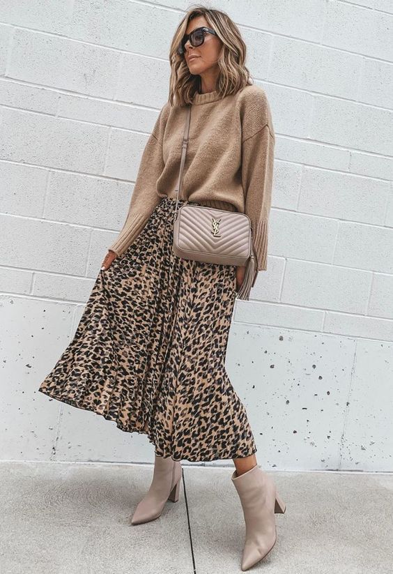 a simple and cute fall outfit with a tan sweater, a leopard print midi, nude booties and a nude bag is very girlish