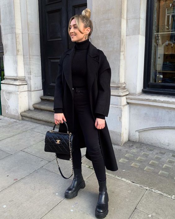 a total black fall look with a turtleneck, skinnies, chunky boots, a midi coat and a bag is a timeless idea