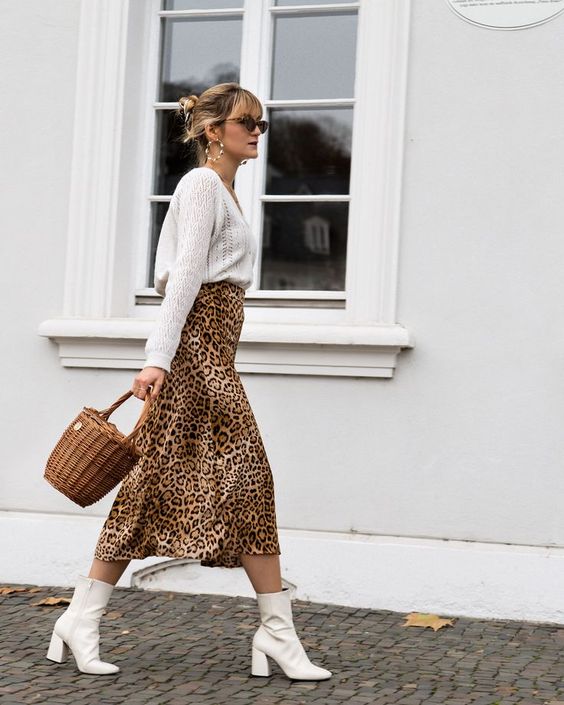 a white V-neck jumper, a leopard print midi, white boots and a basket as a bag are amazing for a girlish fall look