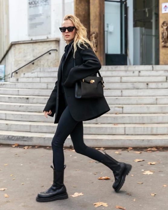 a total black look with a sweater, a blazer, skinnies, tall chunky Chelsea boots and a bag