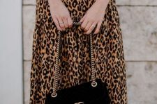 18 an elegant fall outfit with a greige top, a leopard printed midi, black sock boots and a black logo bag