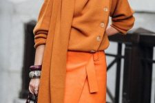 20 a sophisticated fall outfit with an orange jumper and a scarf, a bold orange wrap midi skirt, brown shoes and a mustard bucket bag