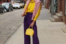 21 a bright fall work look with a yellow ribbed jumper, deep purple pants, a pink jumper over the shoulders, a yellow bag and nude shoes