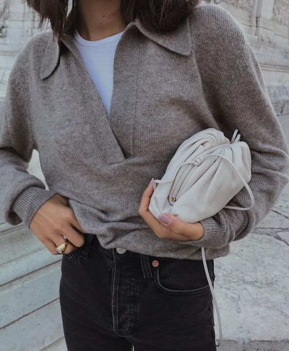 a casual work look with a white top, a grey lapel sweater, black jeans and a neutral bag