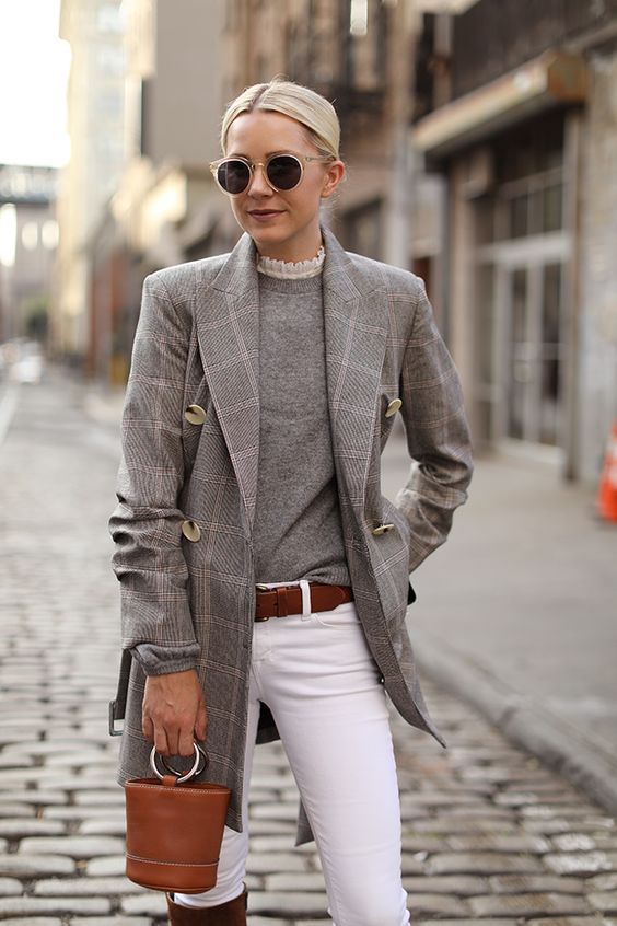 a grey turtleneck, white jeans, a brown belt, a grey plaid oversized blazer, a brown bucket bag