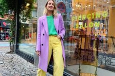 22 a bright pastel look for the fall with a neon grene jumper, yellow jeans, white boots, a purple coat is wow