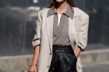 22 a white t-shirt, a grey lapel sweater, black leather shorts, a creamy oversized blazer, a black bag for work
