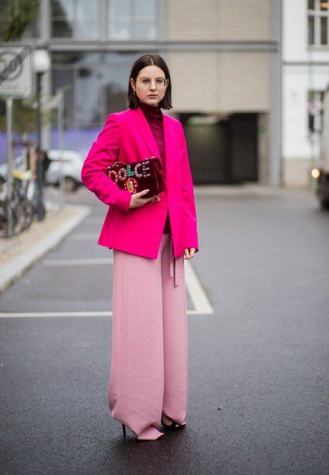 a burgundy turtleneck, a hot pink blazer, light pink trousers and heels, a burgundy velvet bag