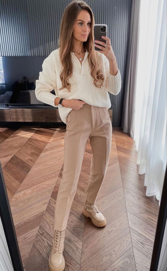 a neutral work look with a creamy lapel sweater, beige pants, beige lace up boots and a necklace is cozy and cool