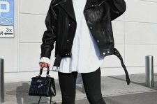 23 a white oversized shirt, a black leather jacket, black chunky boots and a small black bag for a rock-style look