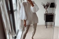 24 an all-neutral fall outfit with a white shirt with puff sleeves, a ribbed waistcoat, creamy leather pants, creamy Chelsea boots