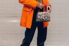 27 a brown jumper, an orange oversized blazer, black velvet pants, snakeskin shoes and a matching bag