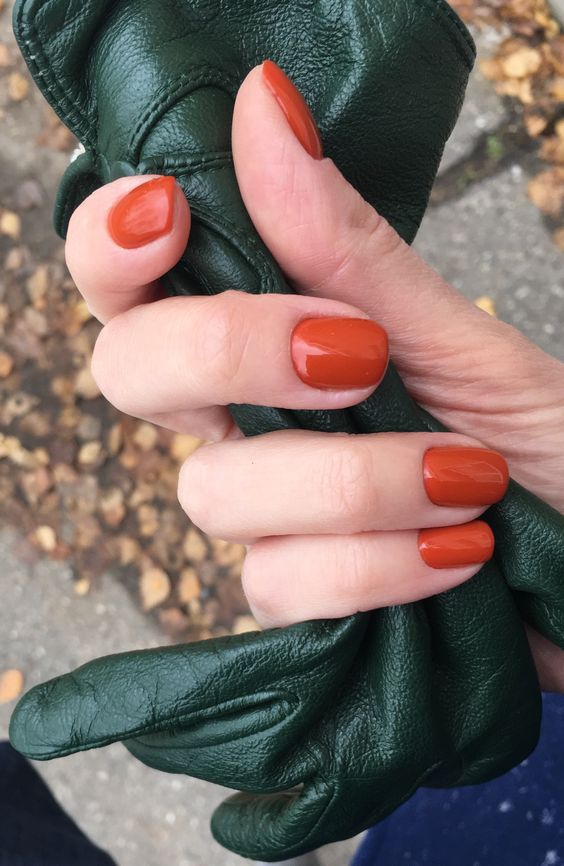 a glossy bold orange manicure is a fantastic idea for the fall, add this traditional fall color to your look