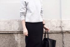 27 a grey sweatshirt, a black midi pencil skirt and black sneakers for a minimalist fall work look