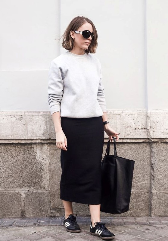 a grey sweatshirt, a black midi pencil skirt and black sneakers for a minimalist fall work look