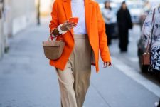 29 a lovely work outfit with a white t-shirt, an orange oversized blazer, tan high waisted pants, a brown mini bag
