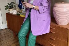 29 a refined and bright fall work look with a white t-shirt, an oversized purple blazer, green leather pants, electric blue heeled mules