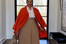 30 a neutral fall work outfit with a white shirt, a beige pleated midi, nude shoes and a bag accented with a bold orange coat