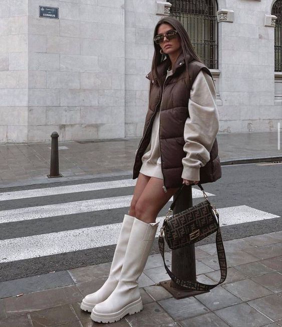 a sweatshirt mini dress, white chunky boots, a brown quited vest, a printed bag are a great outfit for the fall