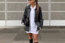 32 a white shirtdress, a black leather jacket, black knee chunky boots, a black bag for a laconic and bold fall look