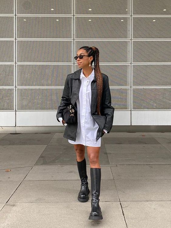 a white shirtdress, a black leather jacket, black knee chunky boots, a black bag for a laconic and bold fall look