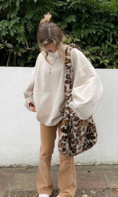 With beige oversized sweatshirt, light brown suede flare pants and white lace up flat shoes