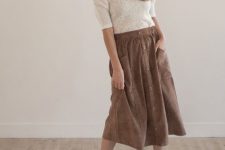 With beige wide brim hat, necklace, brown button front midi skirt and gray suede ankle boots