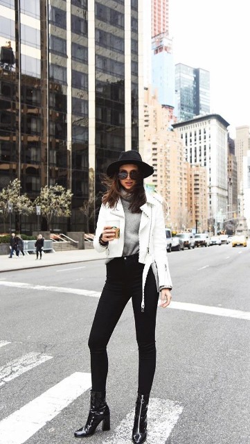 With black wide brim hat, sunglasses, black skinny jeans and black patent leather mid calf boots