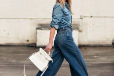 With blue denim button down shirt, white leather bag and floral printed platform shoes
