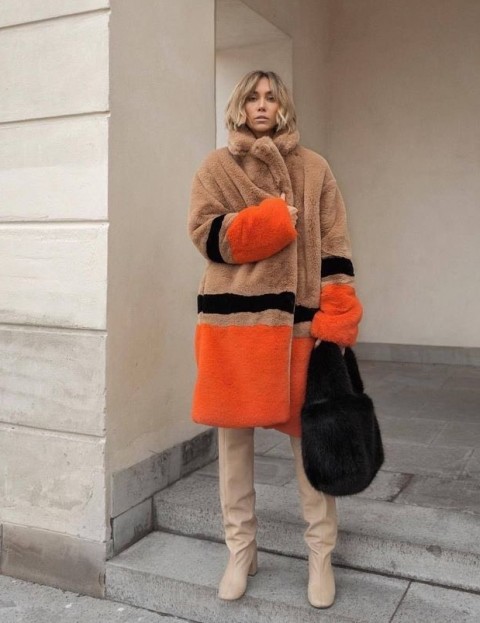 With brown, orange and black knee length faux fur coat and beige leather over the knee boots