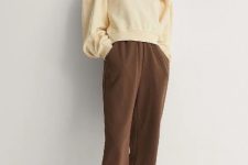 With brown sporty pants and beige and brown lace up flat shoes