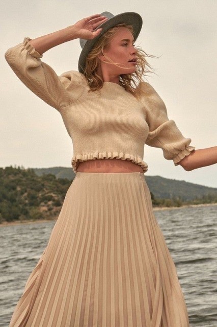With gray wide brim hat and beige high-waisted pleated midi skirt